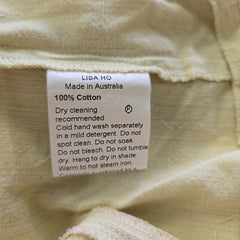 Clothing label on a beige fabric background