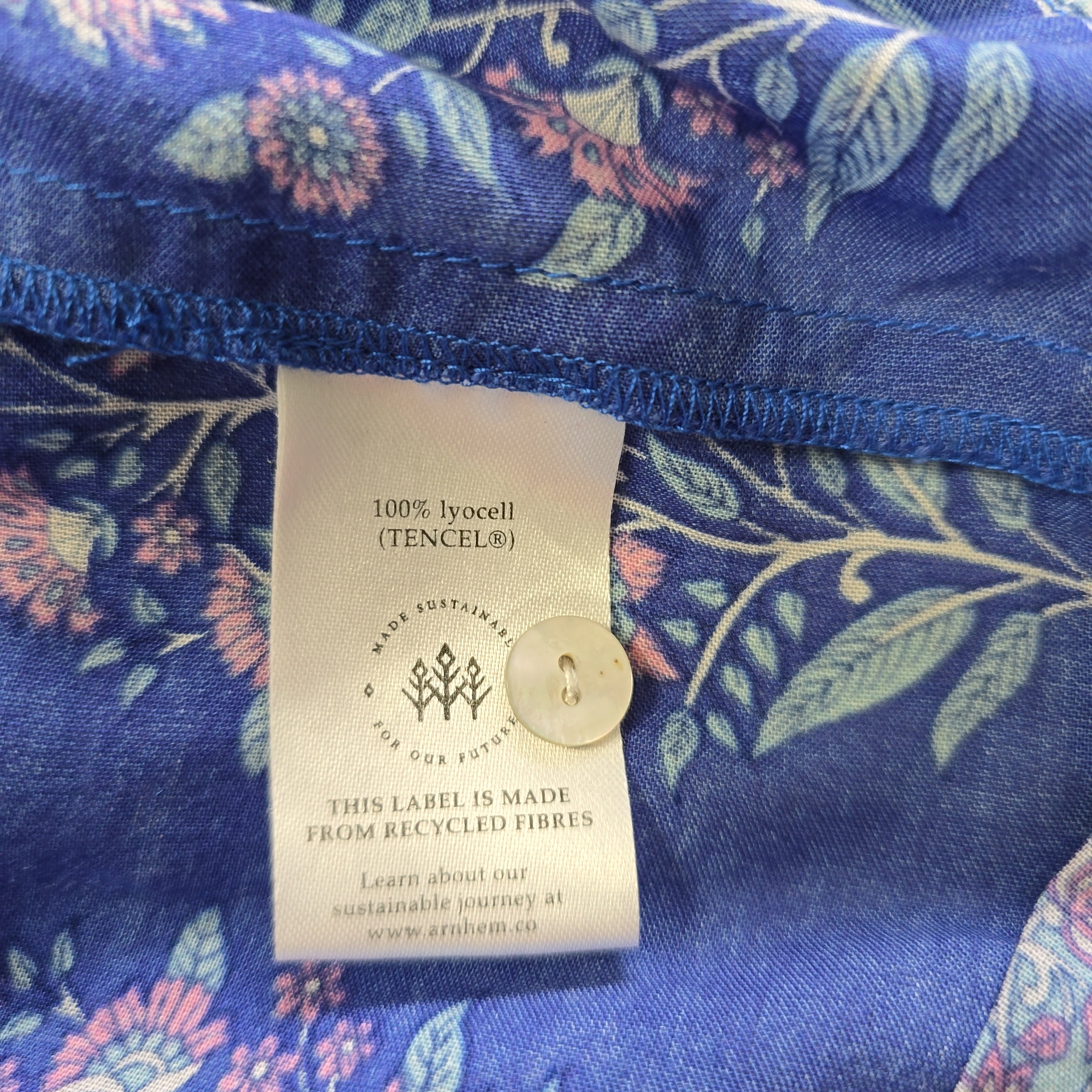 Fabric with floral pattern and a visible label on a blue background