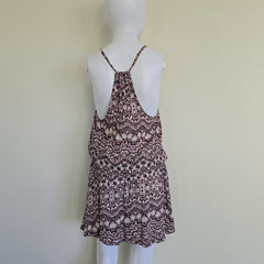 Patterned dress on a mannequin against a plain background