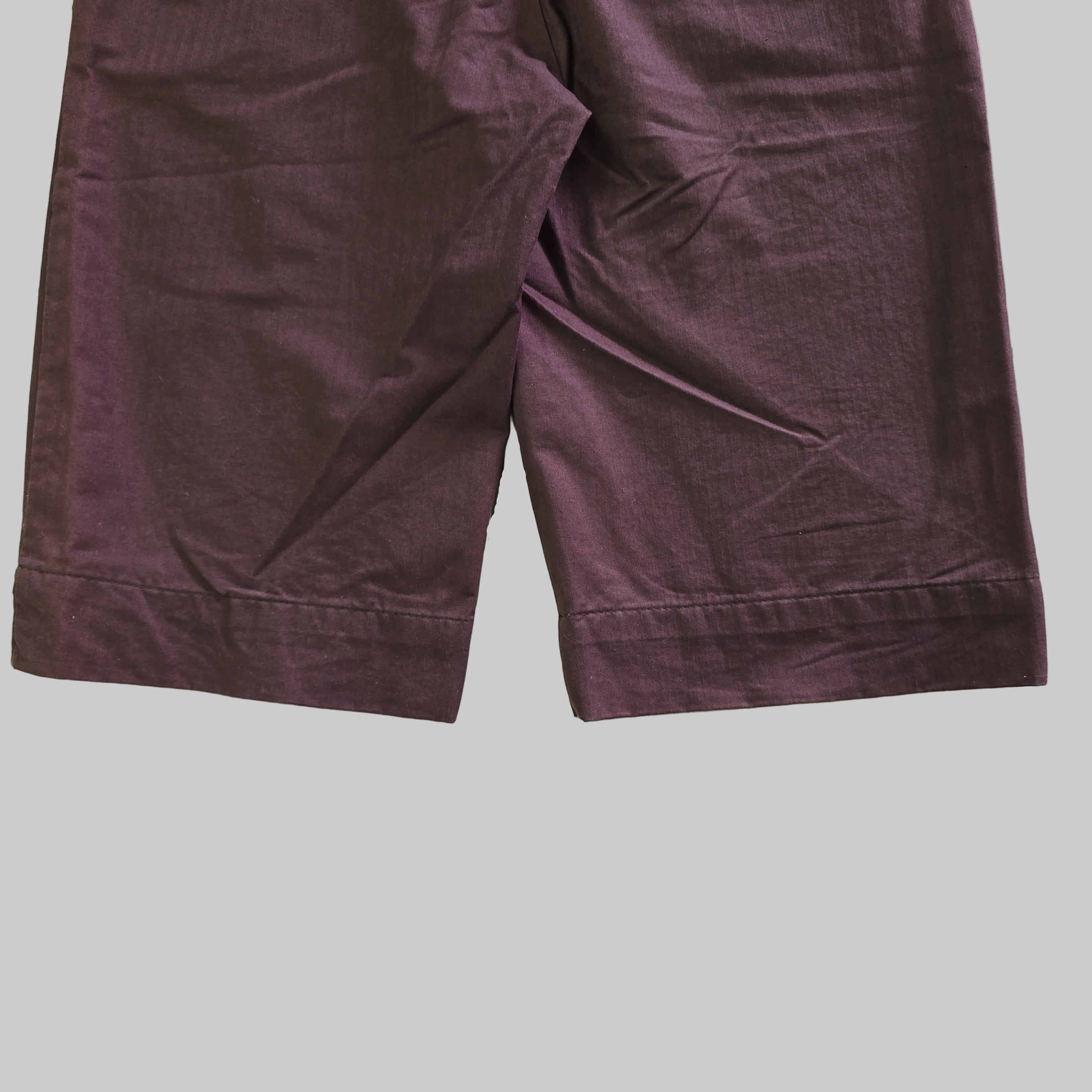 Purple pants on a tiled floor