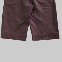 Purple pants on a tiled floor