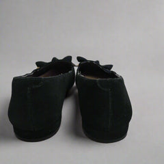 Pair of black shoes on a tiled floor