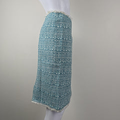 Teal textured fabric skirt on a white background