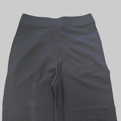 Black dress pants on a tiled floor