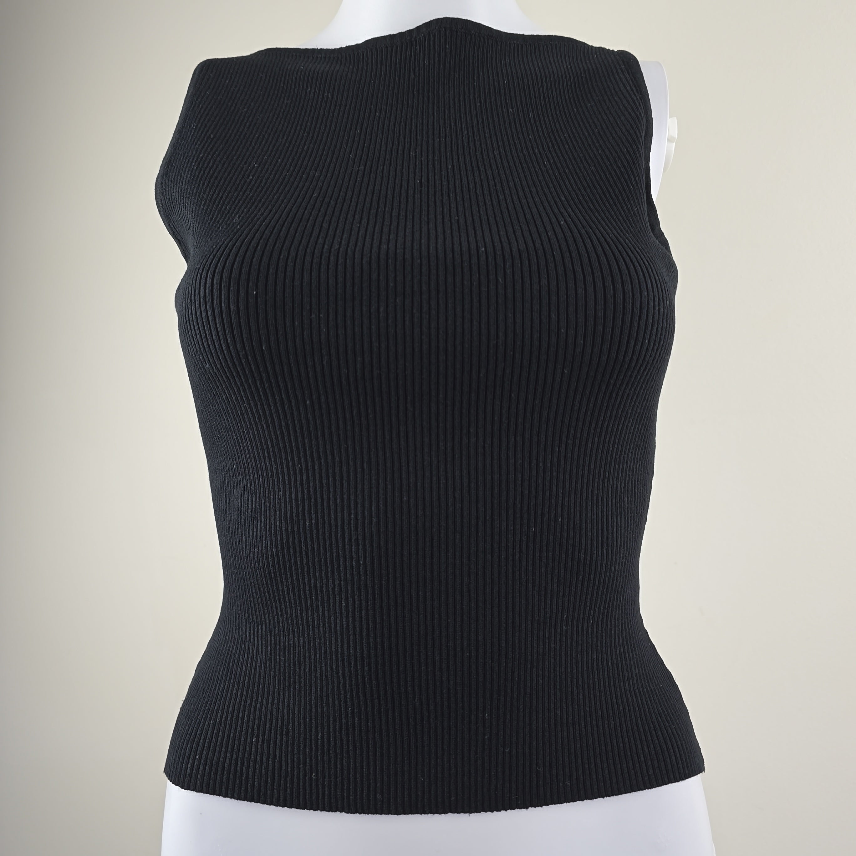 Black knit sleeveless top on a white background