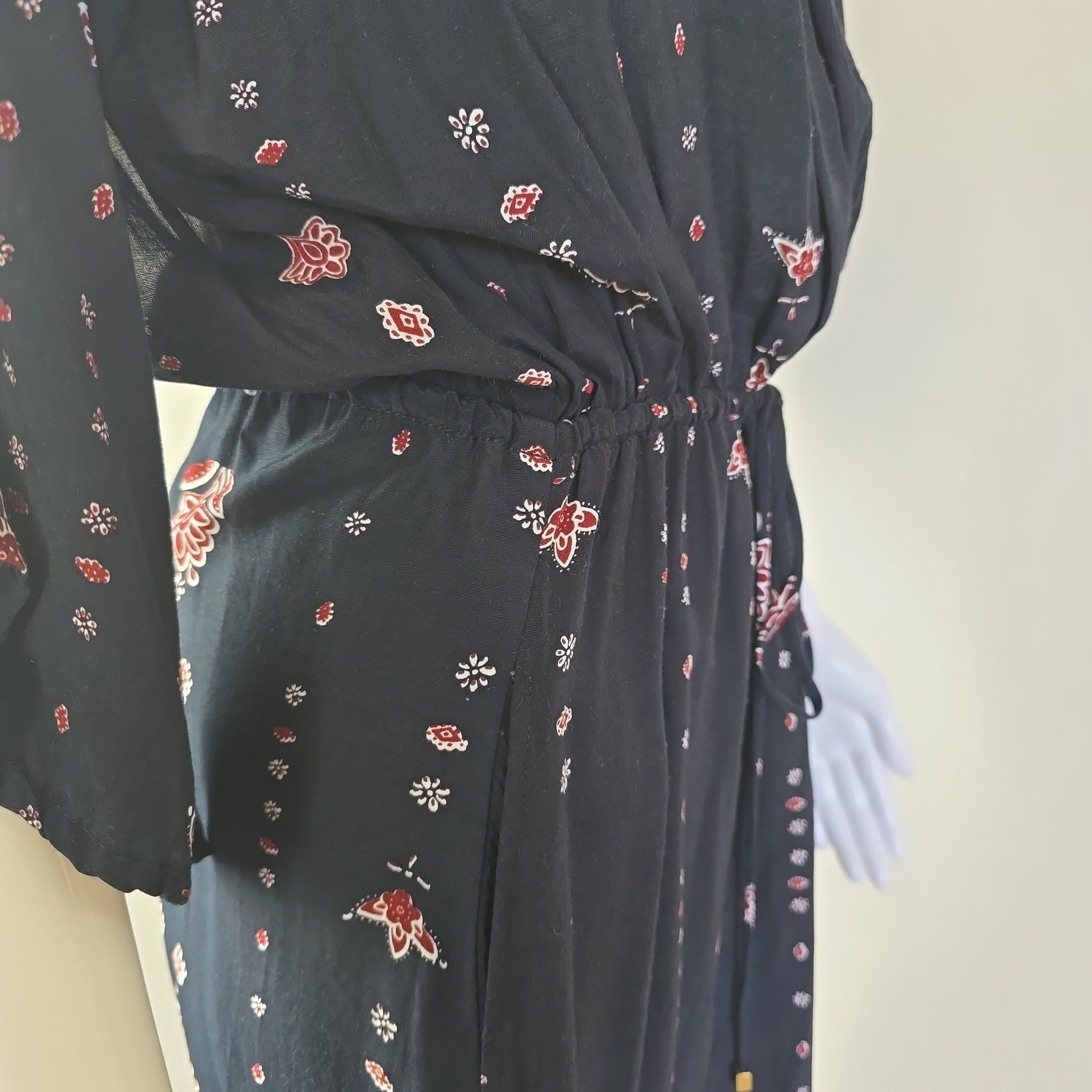 Black dress with floral patterns on a white background