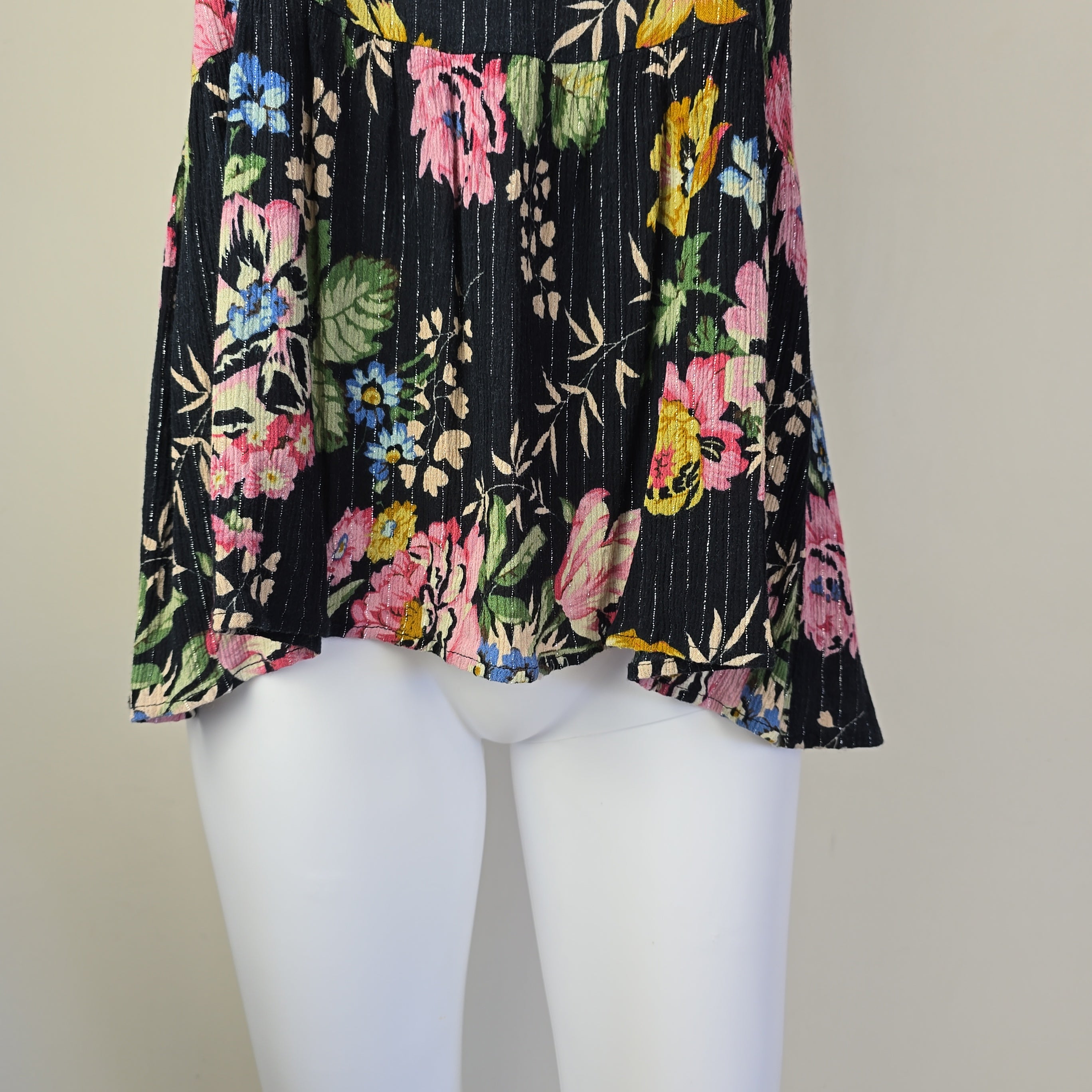 Black floral-patterned top on a light background