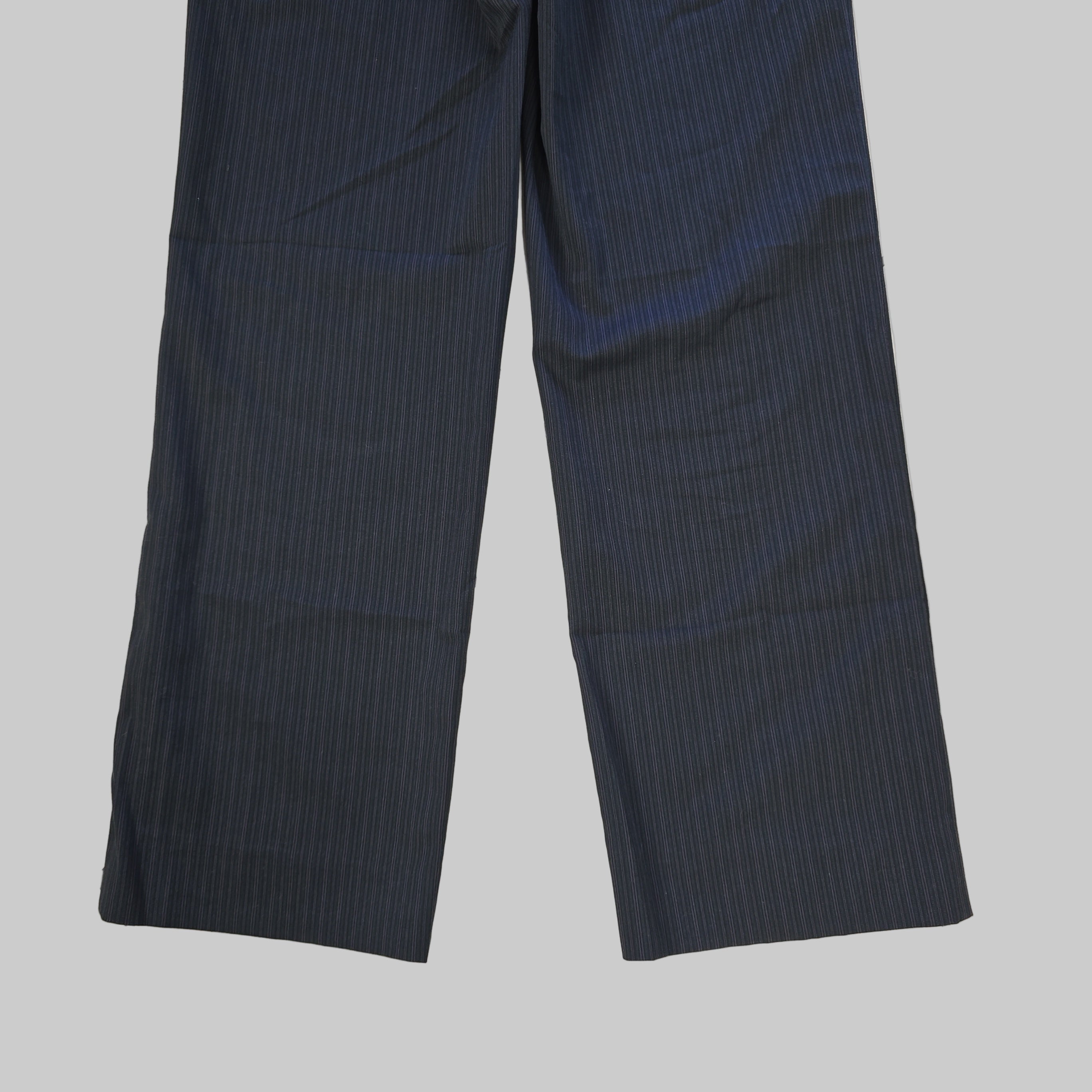 Pair of dark grey pants on a tiled floor