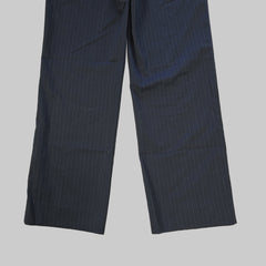 Pair of dark grey pants on a tiled floor