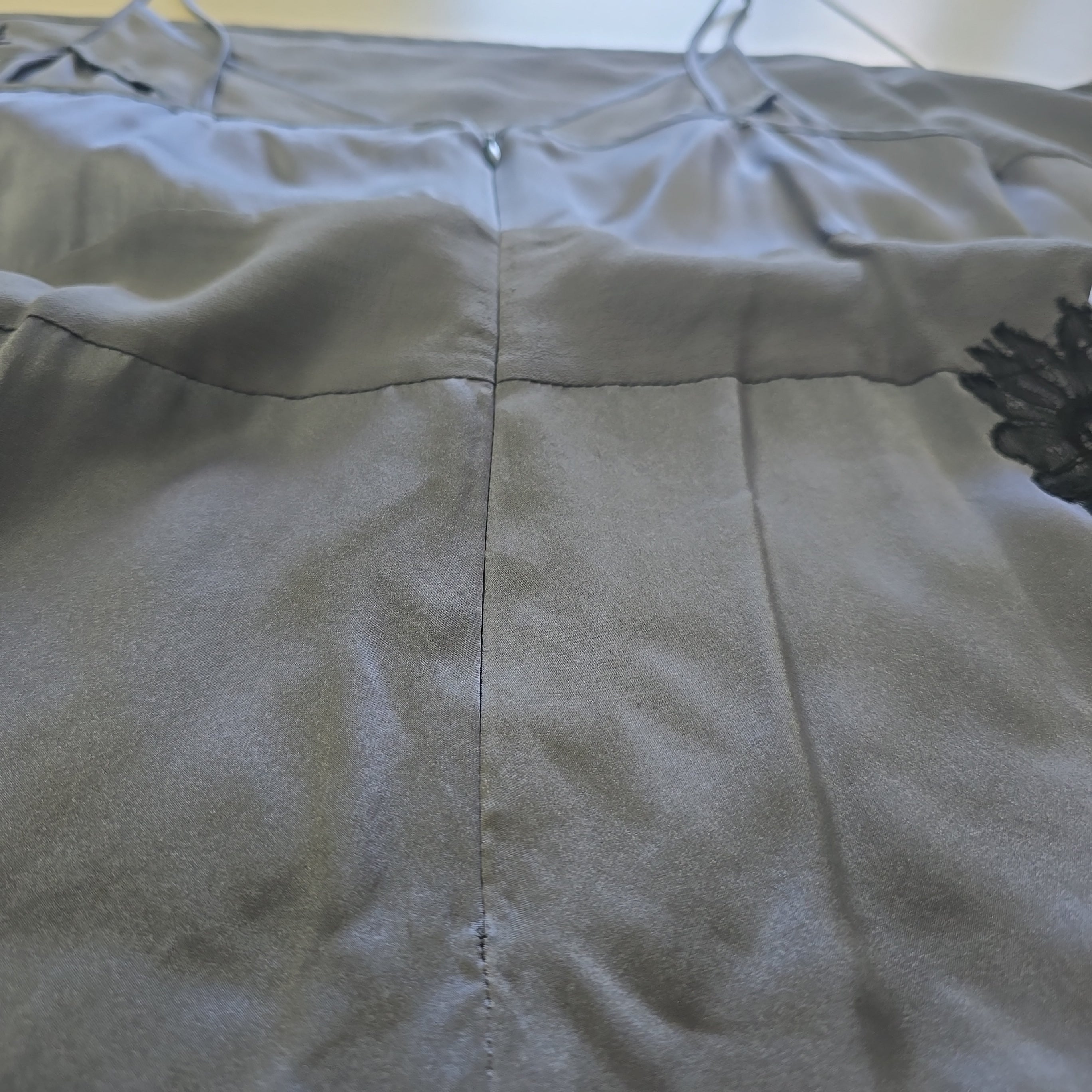 Close-up of a gray dress with floral pattern on a blurred background