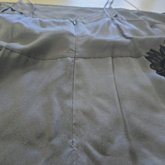 Close-up of a gray dress with floral pattern on a blurred background