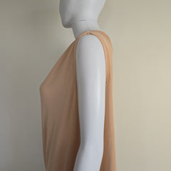 Mannequin wearing a beige top on a plain background