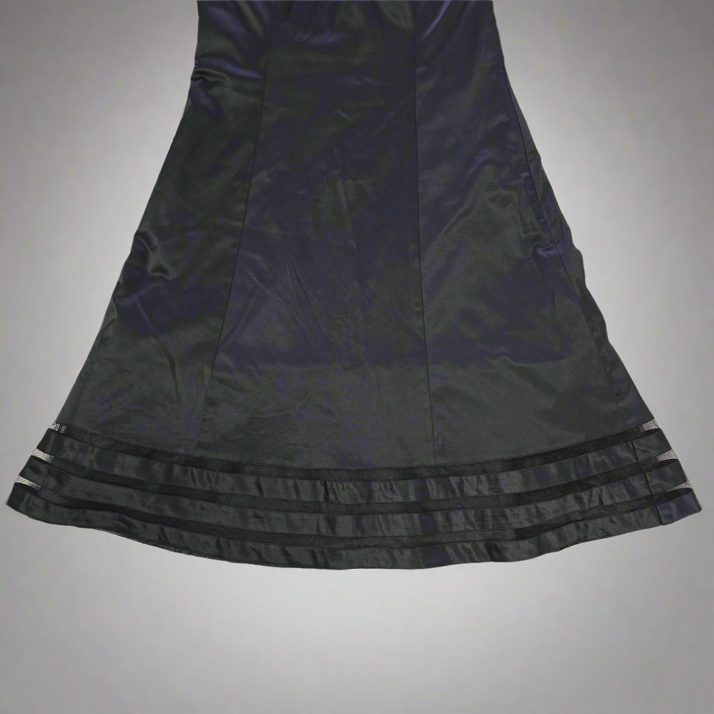Black satin garment on a tiled floor