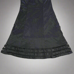 Black satin garment on a tiled floor
