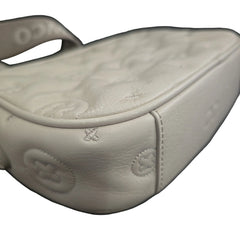 Grey shoulder bag with gold accents on a light background