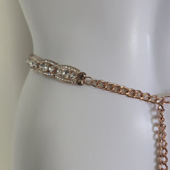Rose gold belt on a mannequin against a white background