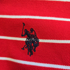 Close-up of a red and white striped fabric with a black embroidered logo.