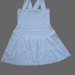 Light blue ribbed top with thin straps on a tiled floor