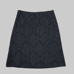 Black textured fabric on a white tiled floor