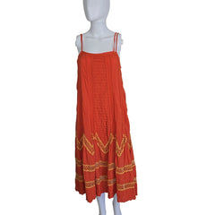 Orange dress with gold embroidery on a mannequin against a white background