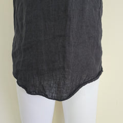Black fabric draped over a white mannequin on a beige background