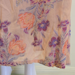 Floral-patterned fabric draped over a mannequin against a neutral background