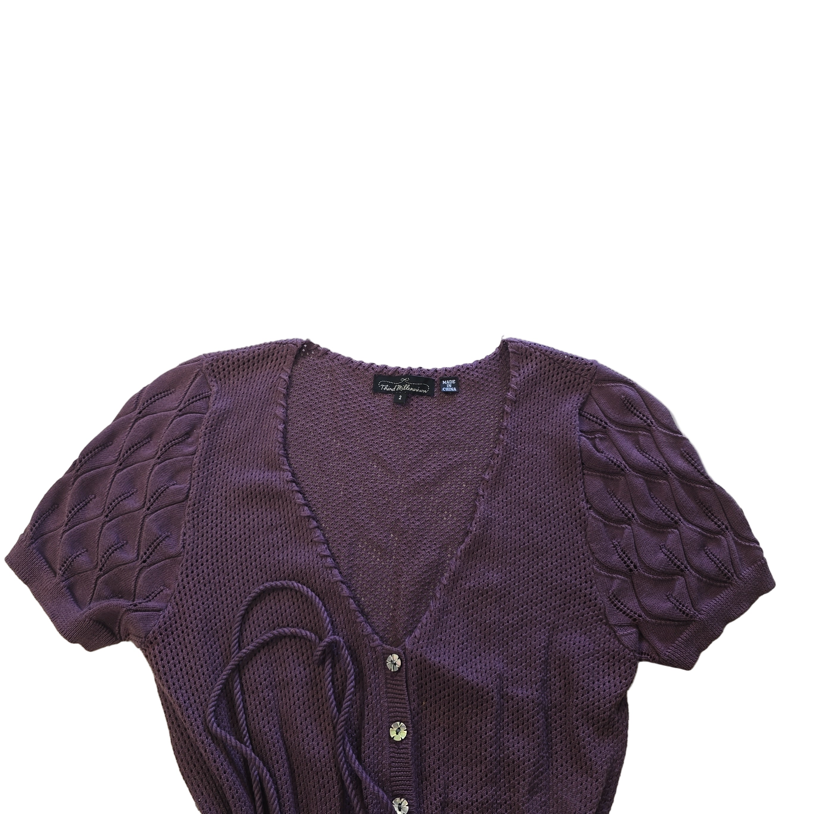 Purple textured garment on a tiled floor