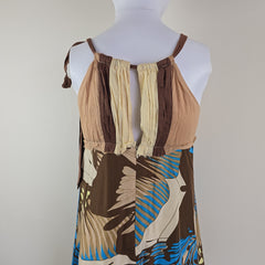 Mannequin wearing a dress with brown, beige, and blue abstract pattern on a plain background