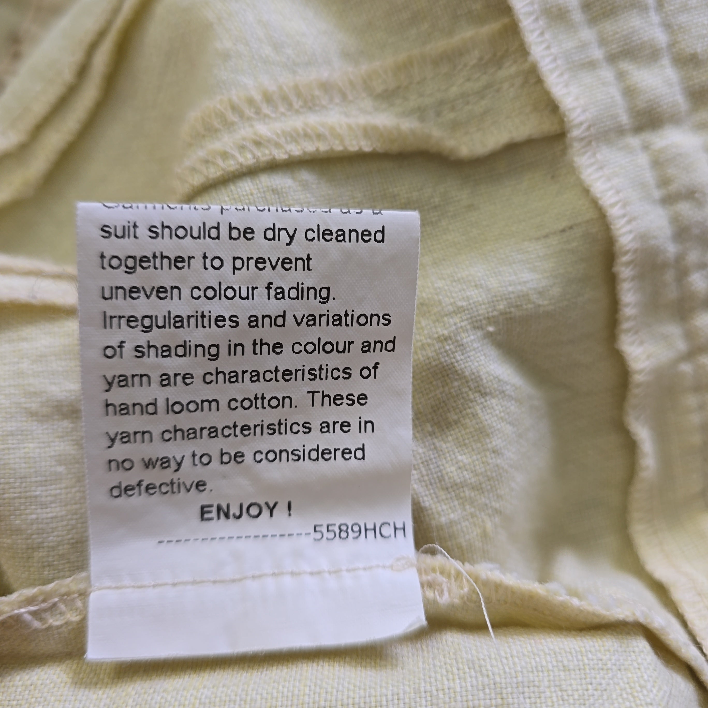 Clothing label on a beige fabric background