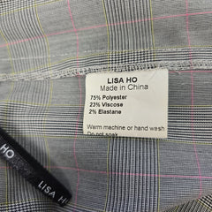 Close-up of a label on a gray checkered fabric with 'Lisa Ho' branding.
