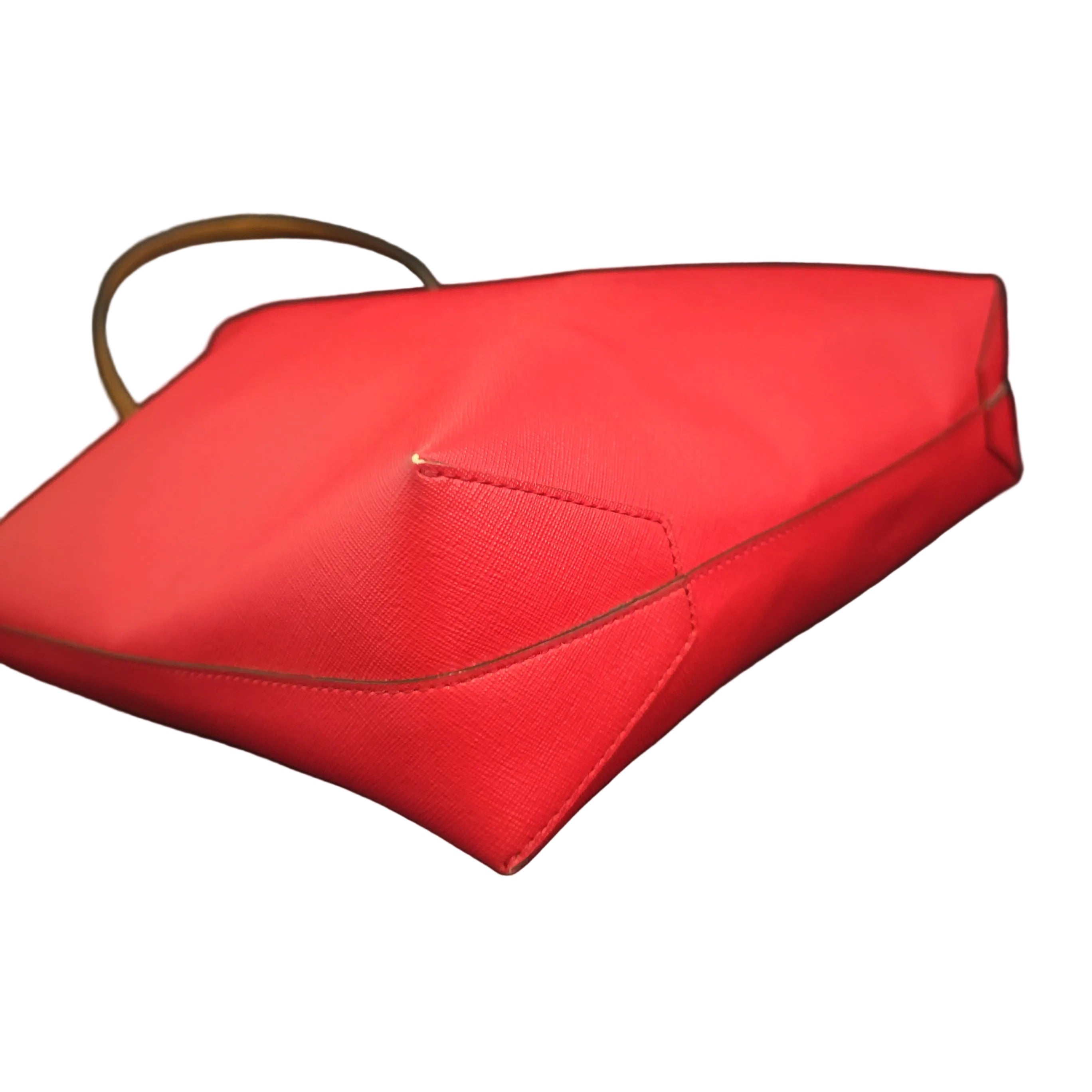 Red handbag with a visible brand logo on a light background