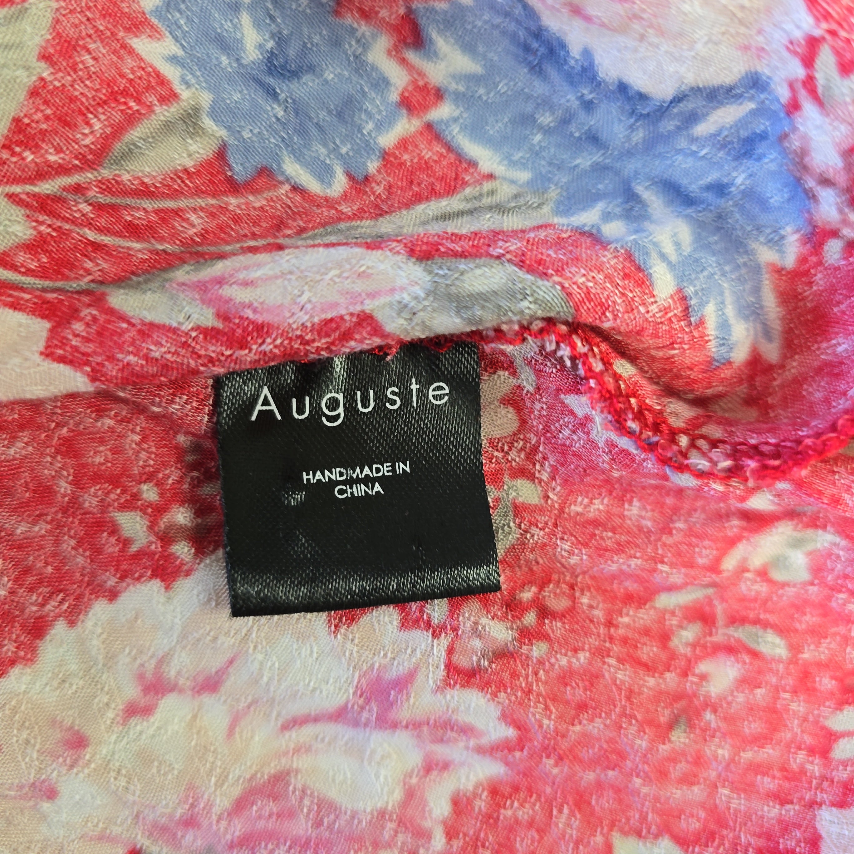 Floral fabric with a 'Auguste' label on a multicolored background