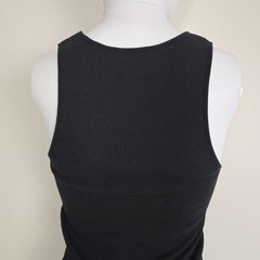Black sleeveless top on a mannequin against a beige background