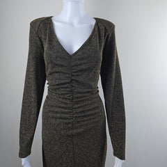 Black and gold textured dress on a mannequin against a light gray background