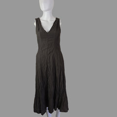 Black dress on a mannequin against a plain background