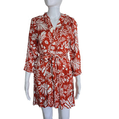 Red and white floral patterned dress on a mannequin against a plain background