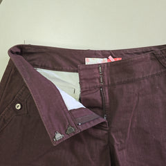 Close-up of a maroon shorts with a beige interior lining on a light background