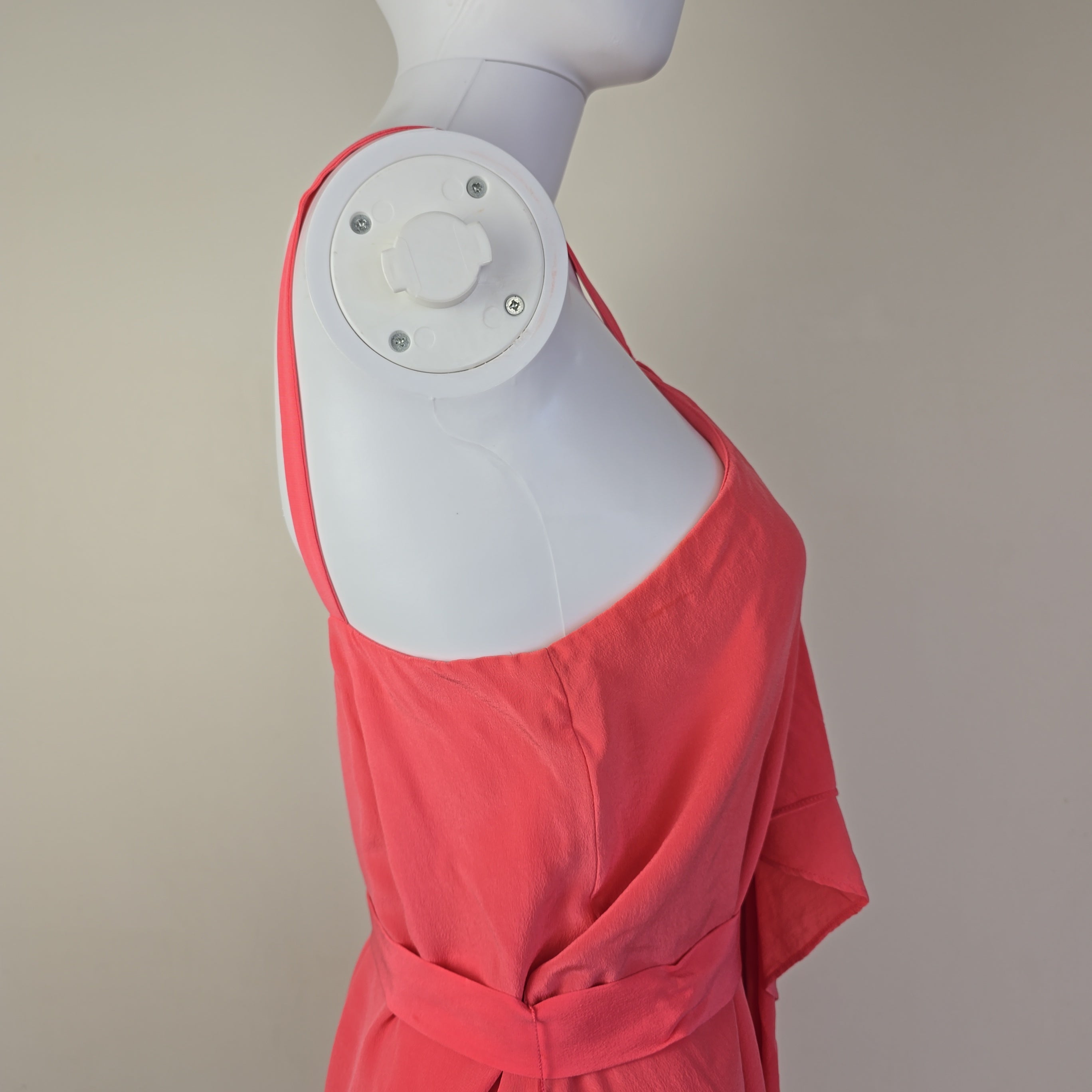 Pink dress on a mannequin with a beige background