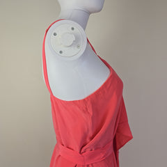 Pink dress on a mannequin with a beige background