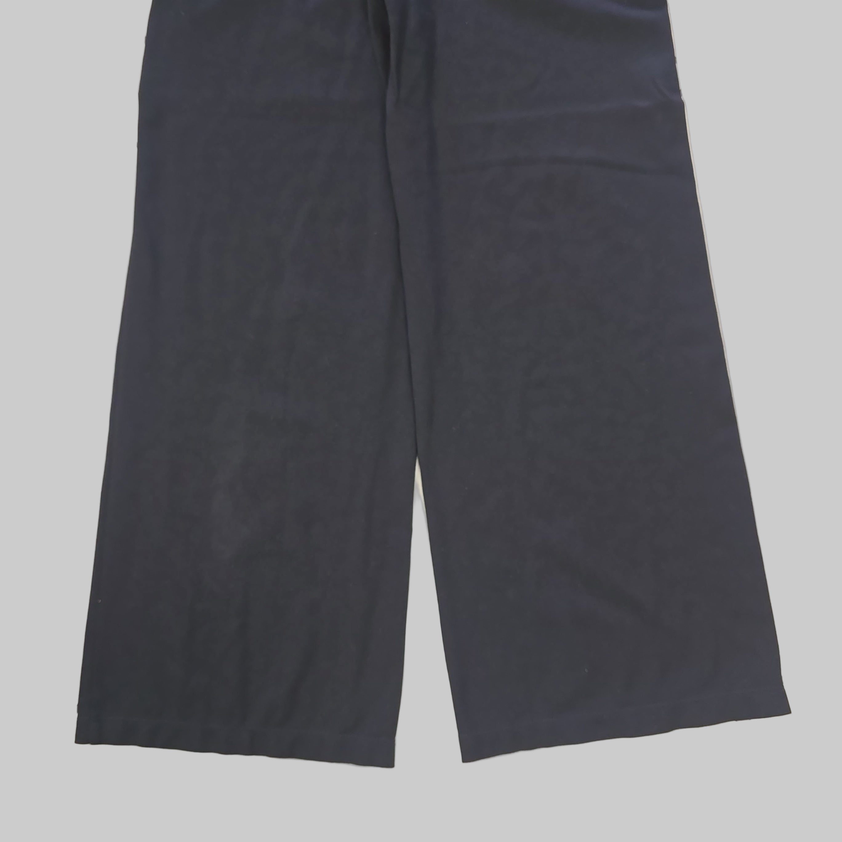 Pair of black pants on a tiled floor