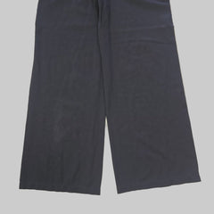 Pair of black pants on a tiled floor