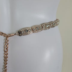 Rose gold belt on a mannequin against a white background