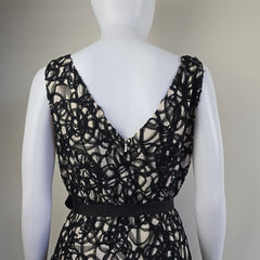 Black lace bra on a mannequin against a neutral background