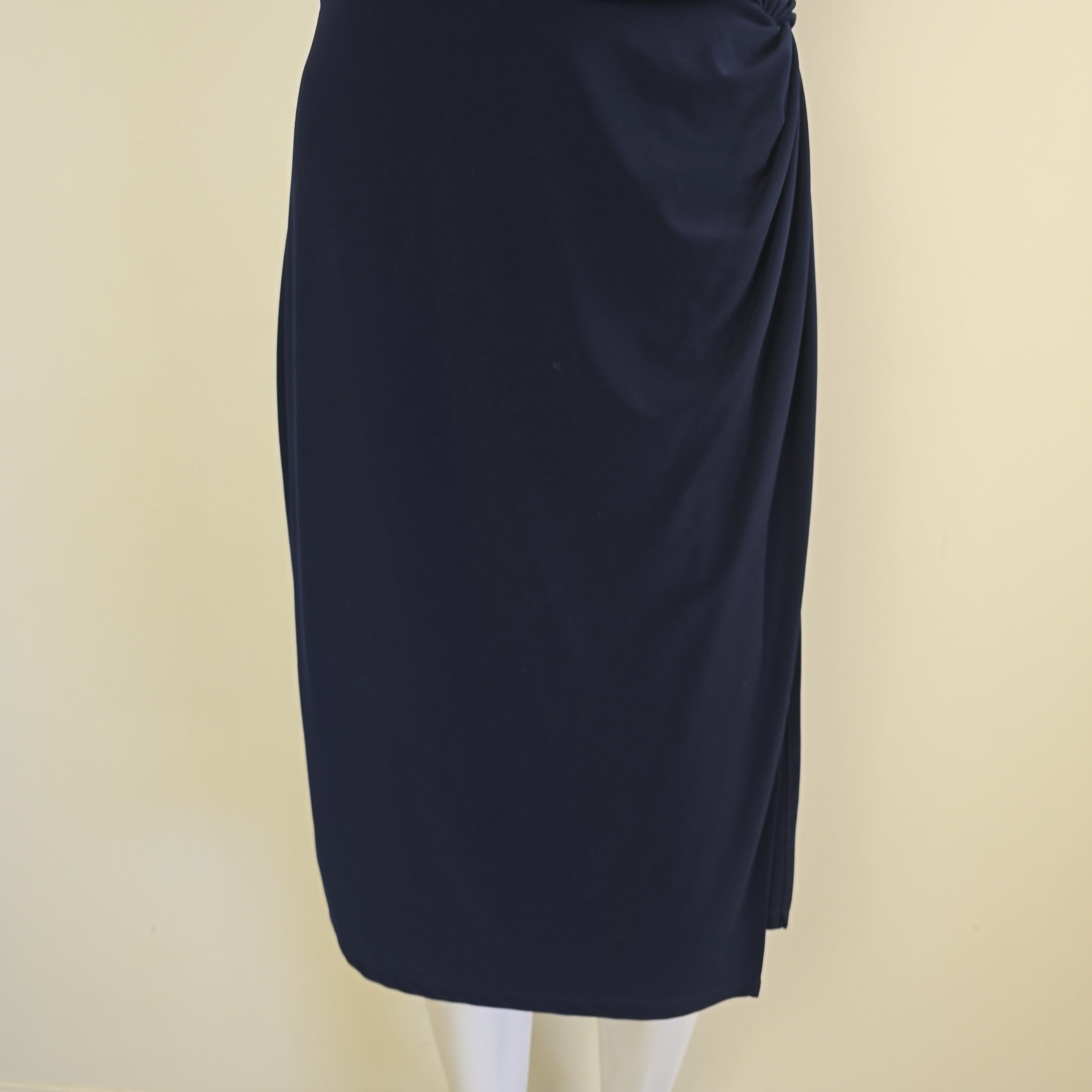 Folded navy blue fabric on a beige background