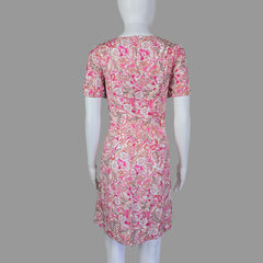Mannequin wearing a pink floral dress on a white background