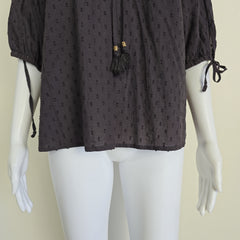 Mannequin wearing a brown patterned garment on a beige background