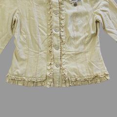 Light yellow jacket with frill details on a light background