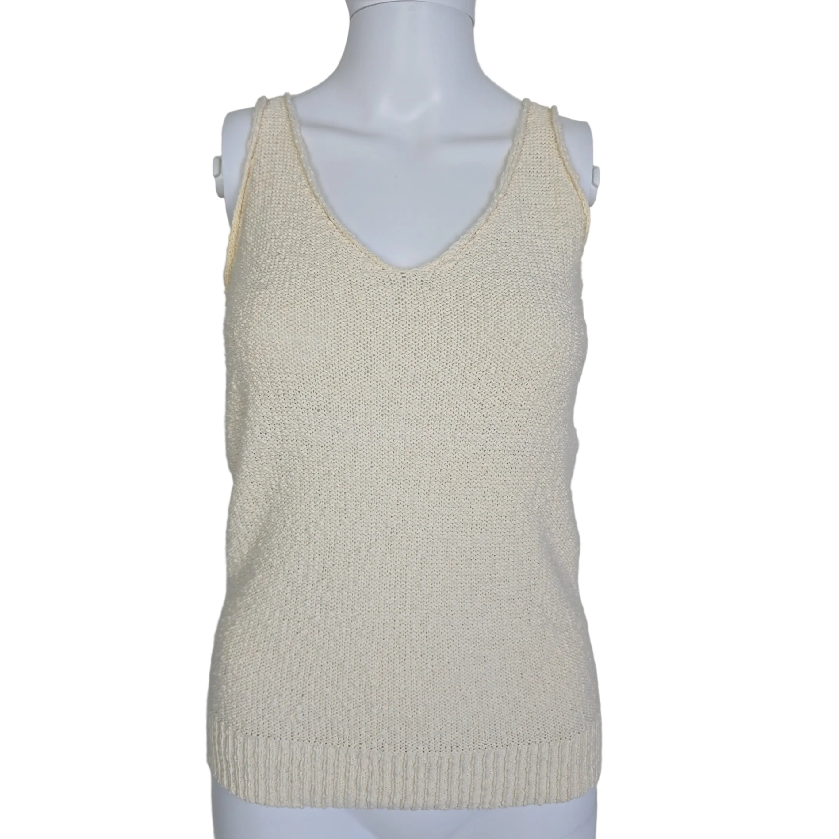 Mannequin wearing a beige sleeveless top on a plain background