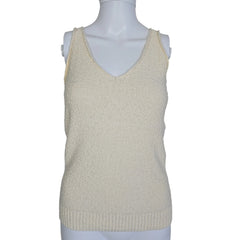Mannequin wearing a beige sleeveless top on a plain background