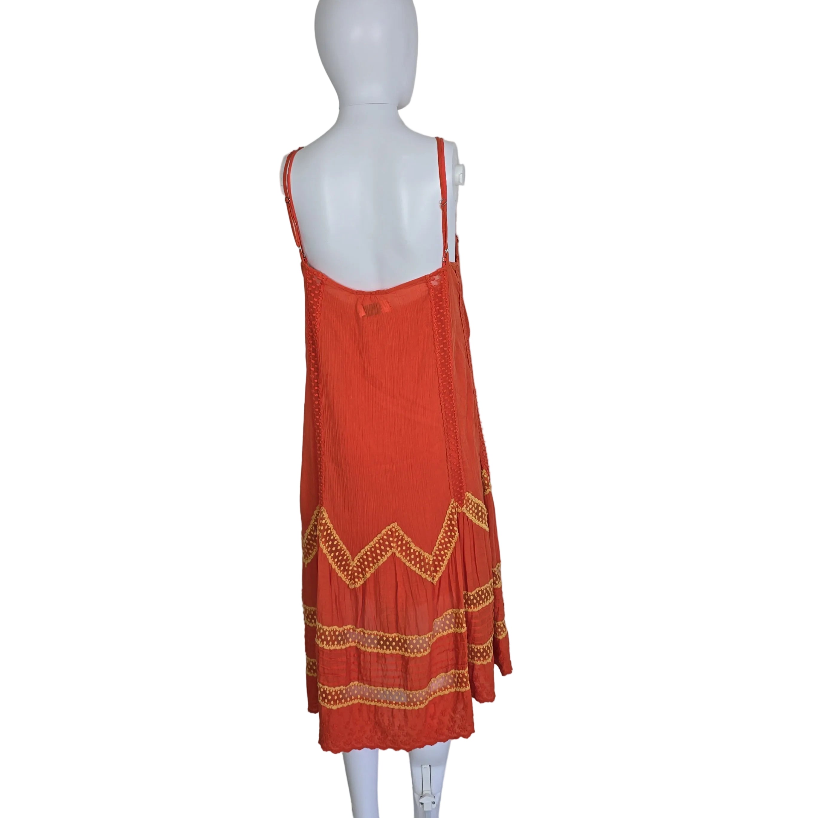 Orange dress with yellow embroidery on a light background